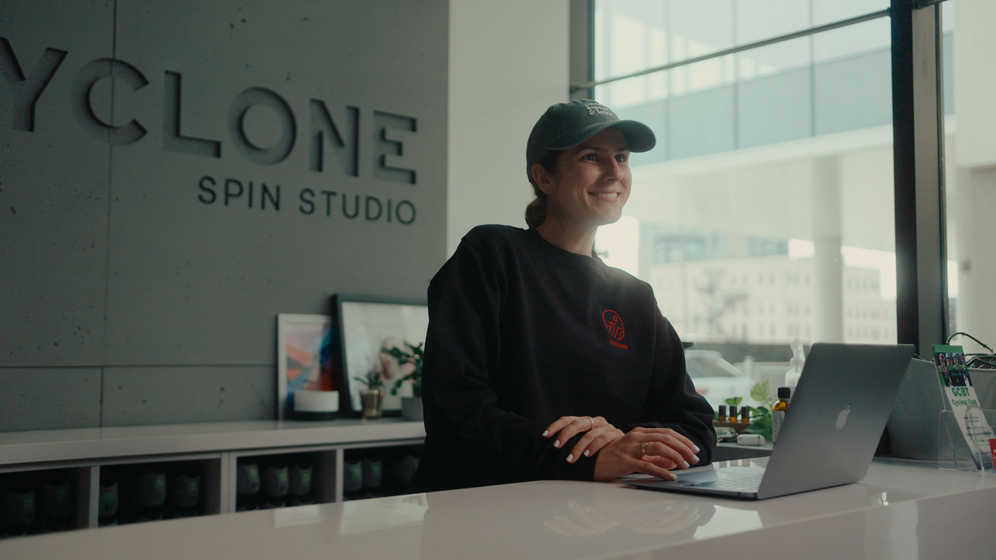 woman smiling at cyclone spin studio reception