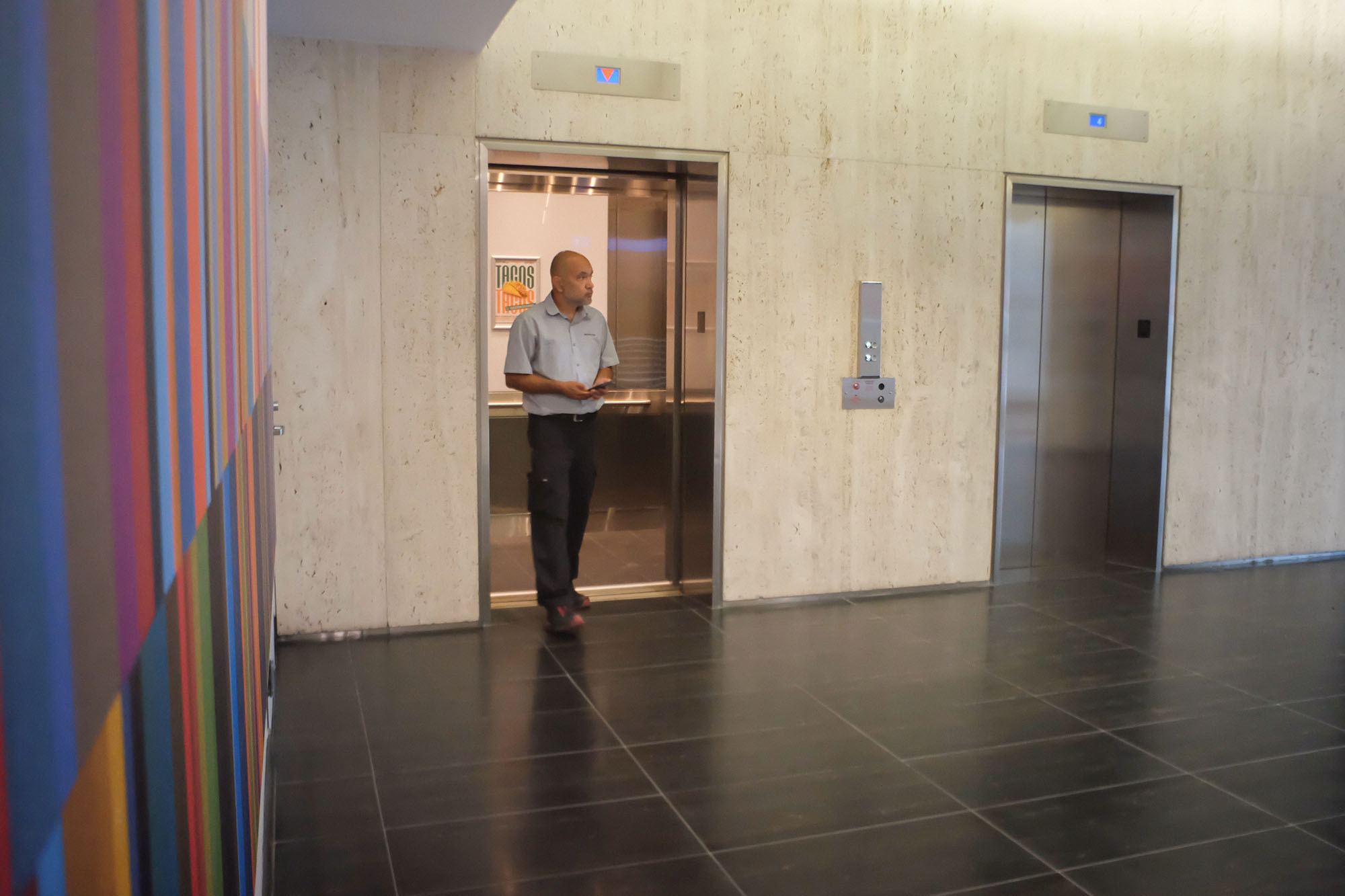 person stepping off elevator