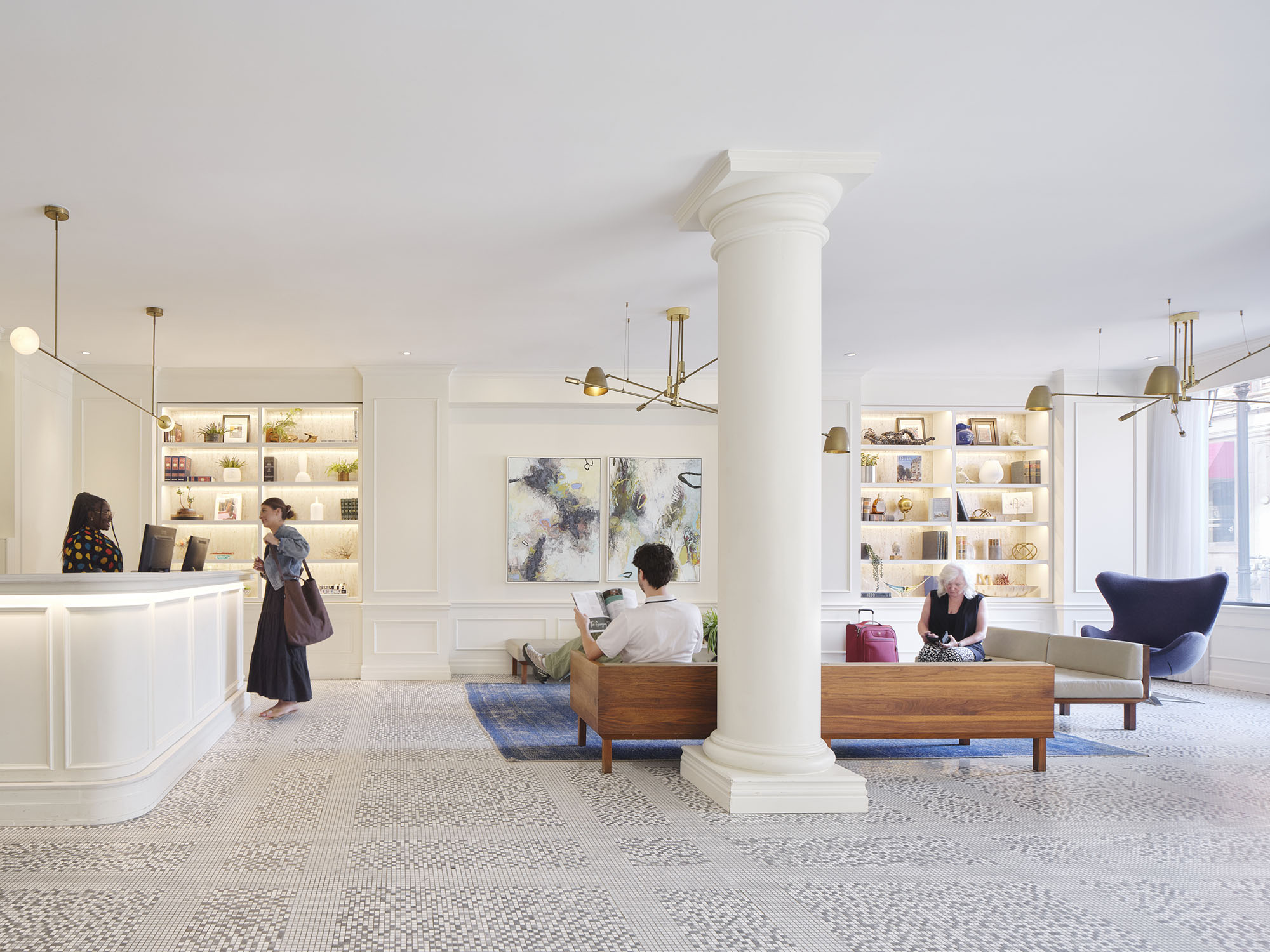 lobby area with people at reception and sitting on couches