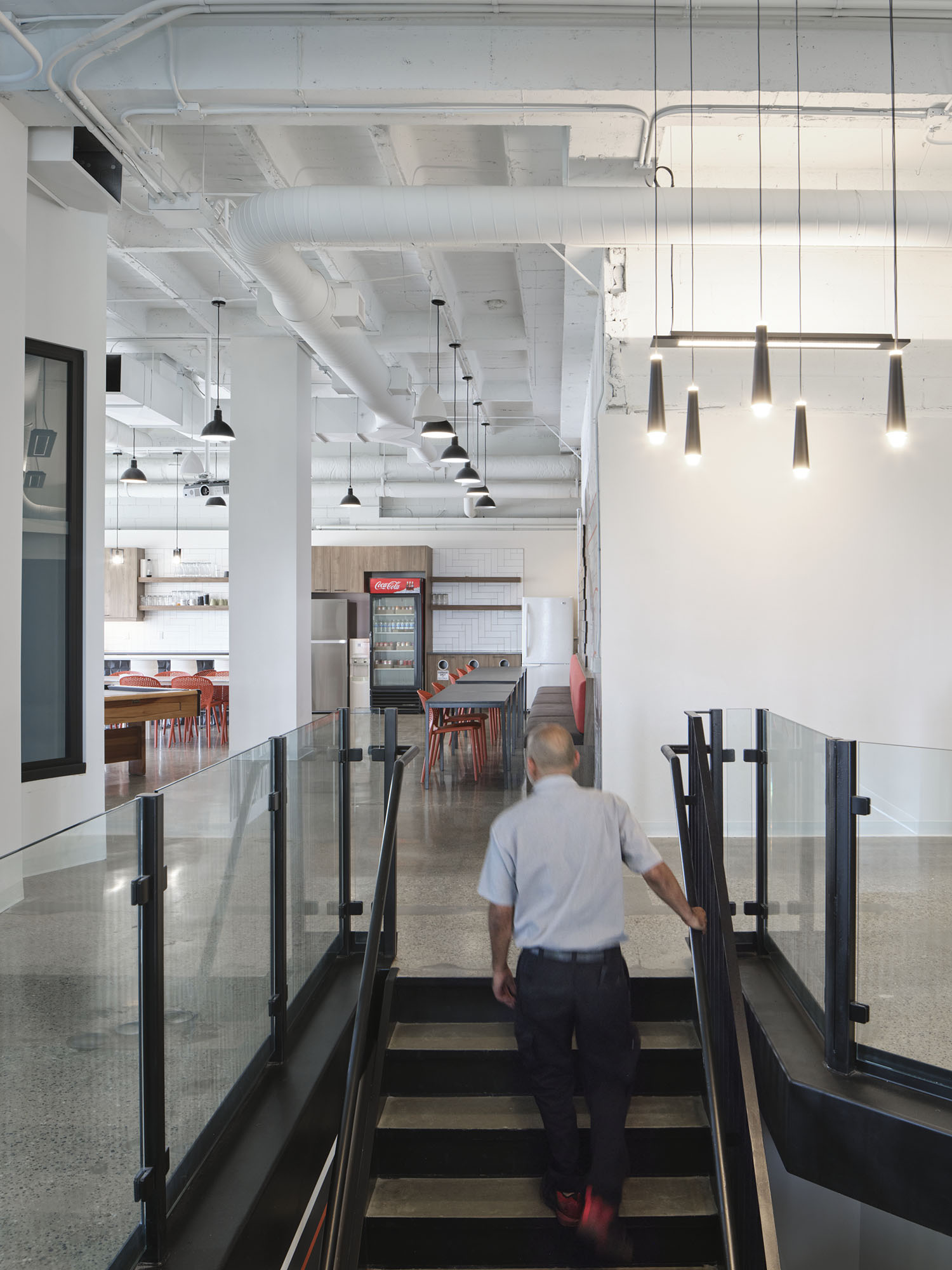 man climbing staircase to open concept office area