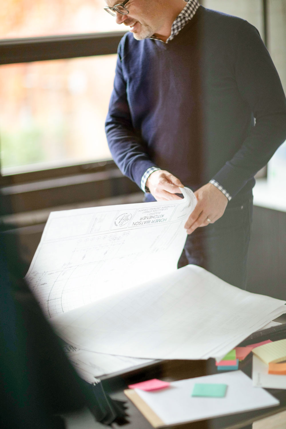 Craig Beattie reviewing architecture drawings at the Perimeter office